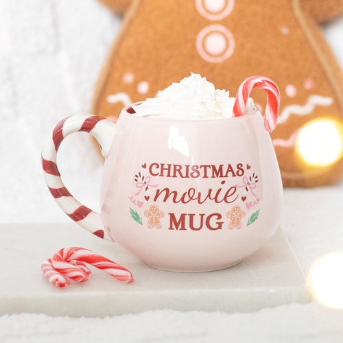 Christmas Movie Night mug with a blush pink finish, candy cane-striped handle and festive Christmas design